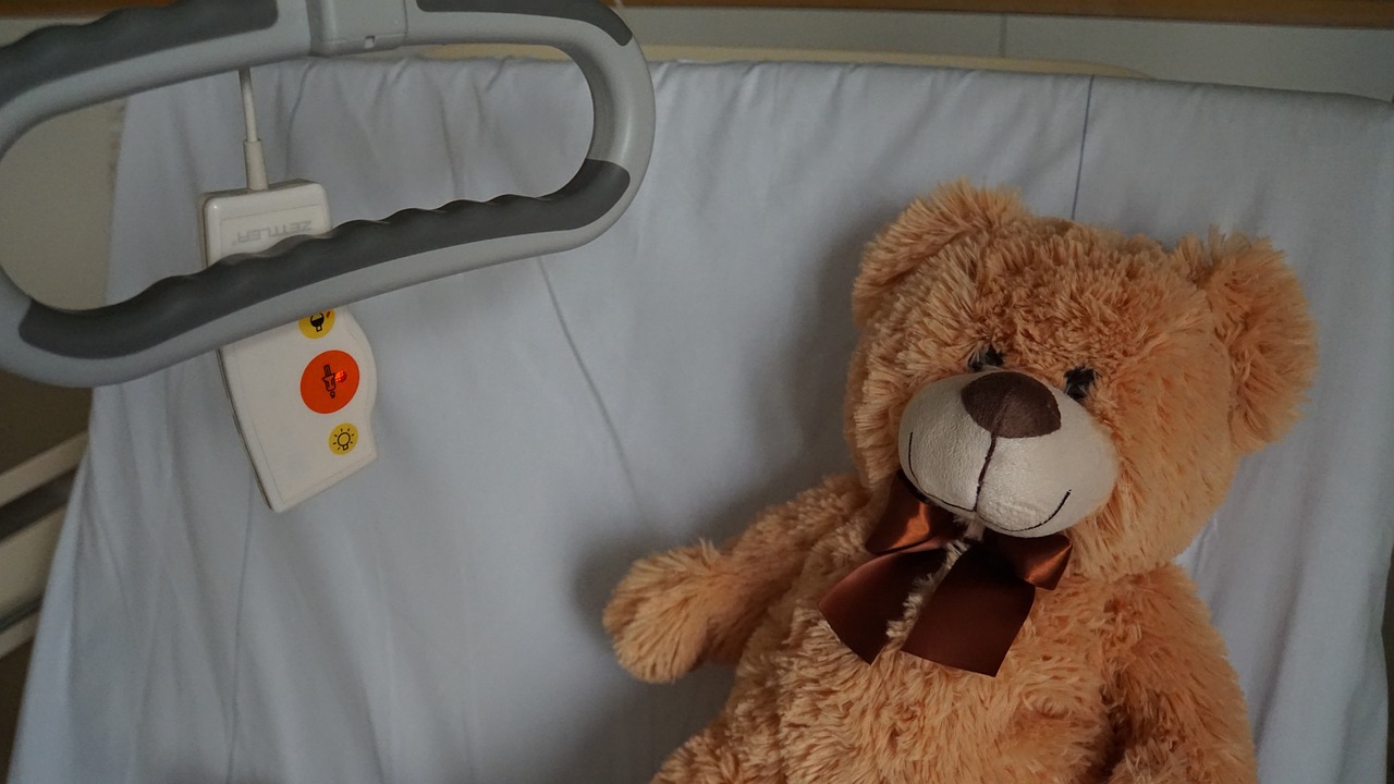 Teddy bear in a hospital bed